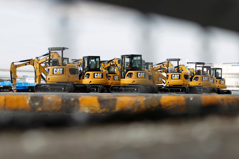 © Reuters. FILE PHOTO: New excavators are seen at a port in Yokohama