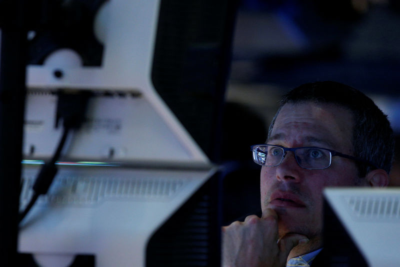 © Reuters. A trader works inside a booth on the floor of the NYSE in New York