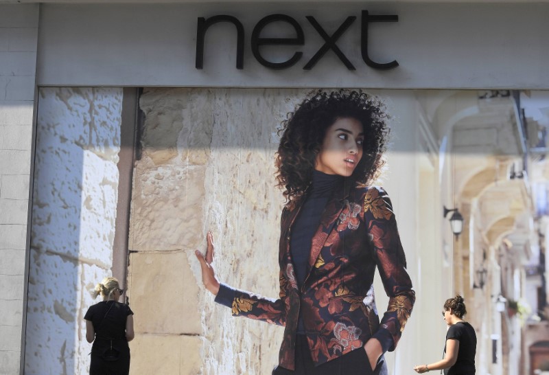 © Reuters. Shoppers pass a branch of Next retail in London, Britain