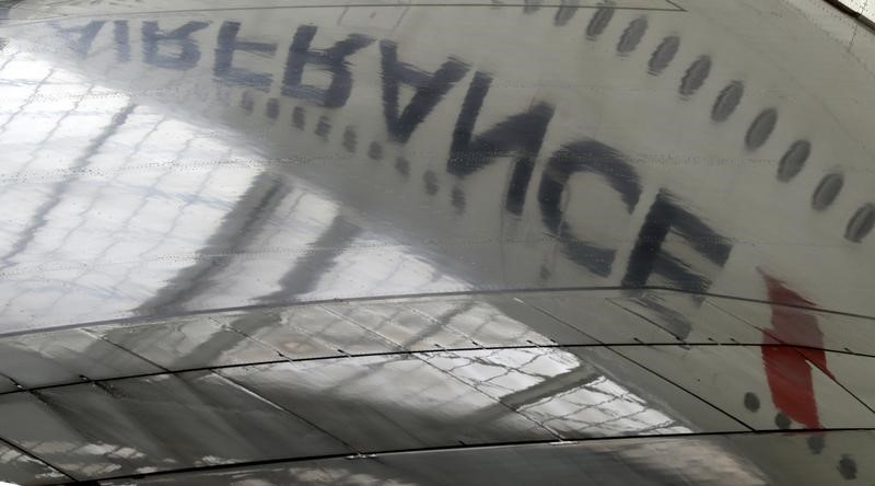 © Reuters. The logo of an Air France Airbus A 380 is reflected in its wing as it is under maintenance in the Air France hangar