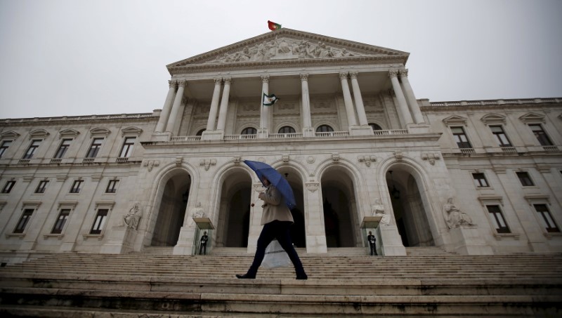 © Reuters. File photo of a woman walking in front of the Portuguese parliament in Lisbon