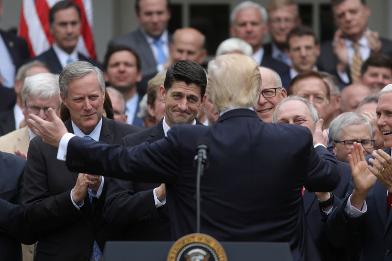 © Reuters. U.S. President Trump turns to Speaker Ryan as he gathers with Republican House members after healthcare bill vote at the White House in Washington