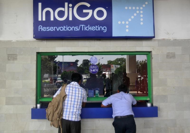 © Reuters. Passengers stand at the ticket counter of Indigo Airlines at the airport on the outskirts of Agartala