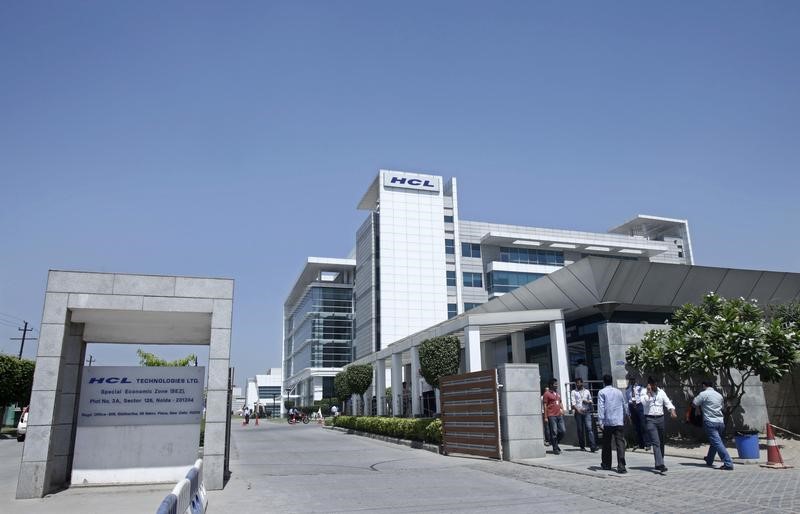 © Reuters. People walk in front of the HCL Technologies Ltd office at Noida