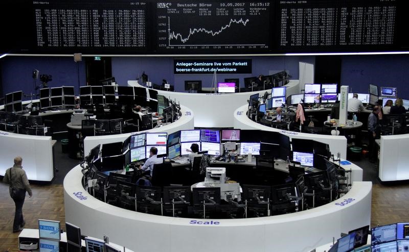 © Reuters. Traders work in front of the German share price index, DAX board, at the stock exchange in Frankfurt