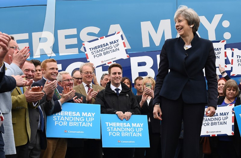 © Reuters. Britain's PM May addresses supporters and members of the media in front of the party's election campaign bus at an airfield north of Newcastle