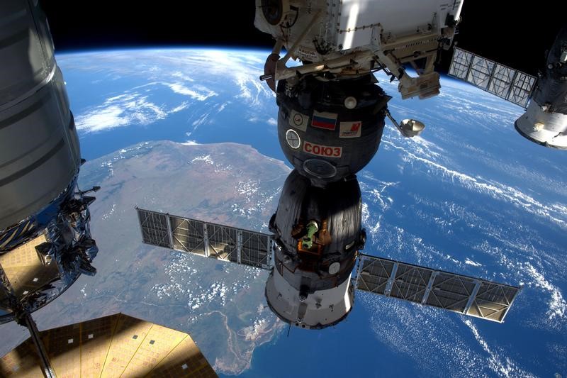 © Reuters. FILE PHOTO: A NASA image showing the International Space Station as it flew over Madagascar showing three of the five spacecraft docked to the station