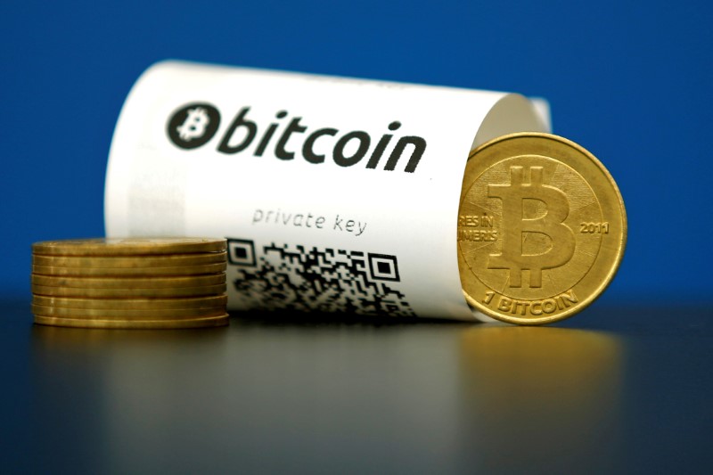 © Reuters. FILE PHOTO - An illustration photo shows a Bitcoin (virtual currency) paper wallet with QR codes and a coin are seen at La Maison du Bitcoin in Paris