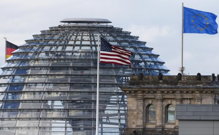 © Reuters. The flag on the U.S. embassy is pictured next to the Reichstag building, seat of the German lower house of parliament Bundestag, in Berlin