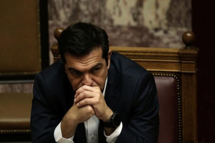 © Reuters. Greek PM Tsipras attends a parliamentary session before a vote on the latest round of austerity Greece has agreed with its lenders, in Athens