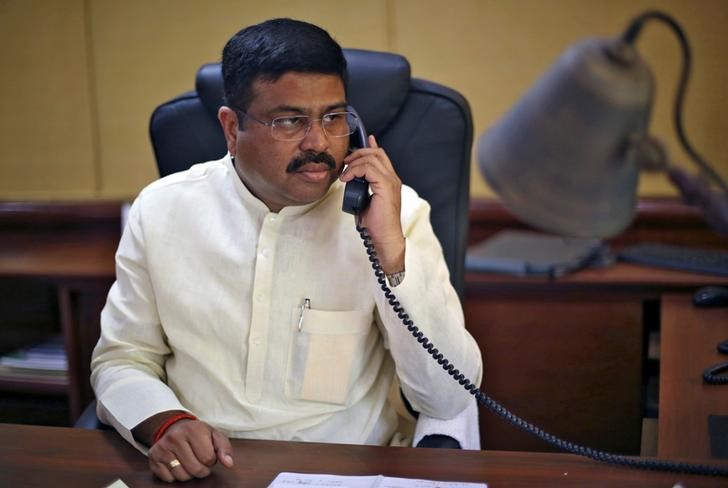 © Reuters. India's Oil Minister Pradhan speaks on phone during an interview with Reuters in New Delhi