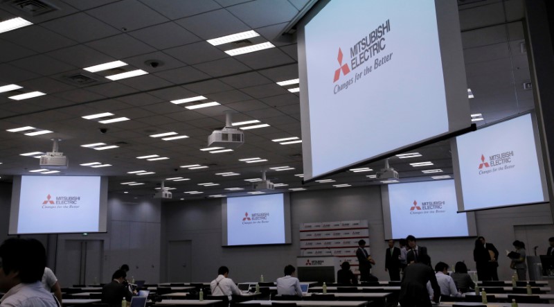 © Reuters. FILE PHOTO: Logos of Mitsubishi Electric Corp are seen at a news conference at the company's headquarters in Toky