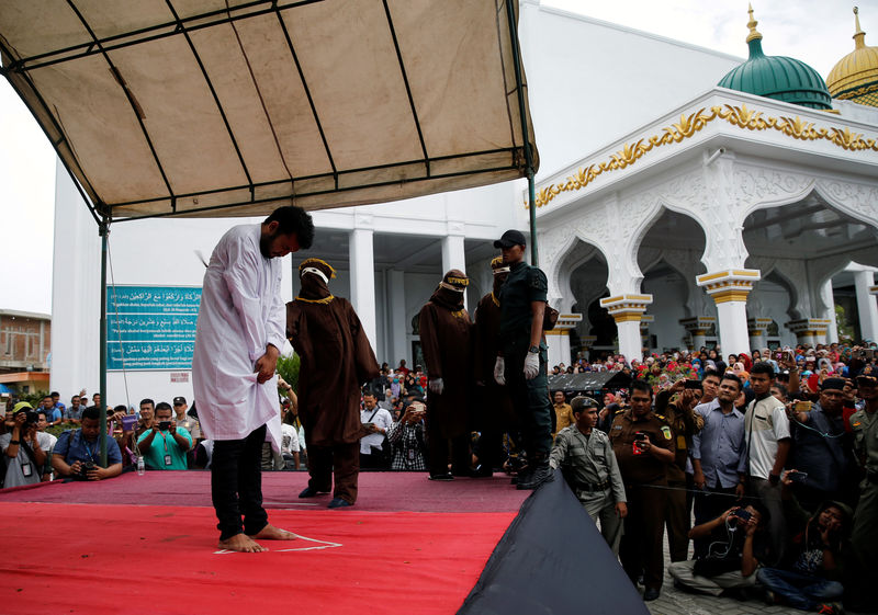 © Reuters. An Indonesian man is publicly caned for having gay sex, in Banda Aceh