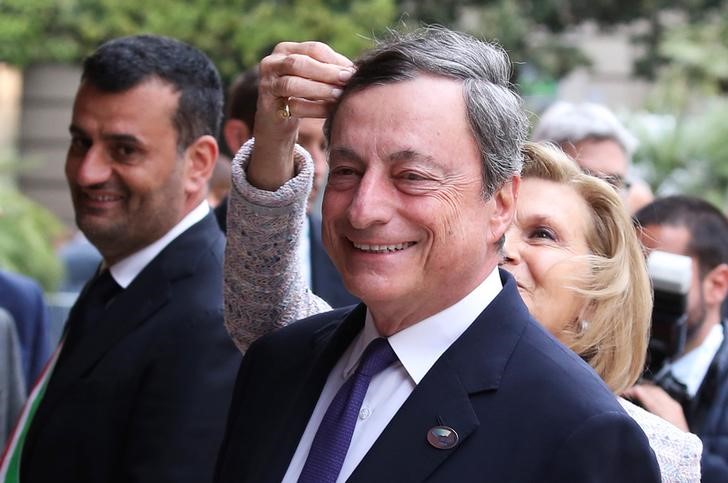 © Reuters. ECB President Mario Draghi smiles as his wife adjusts his hair at the Petruzzelli Theatre during a G7 for Financial ministers in the southern Italian city of Bari