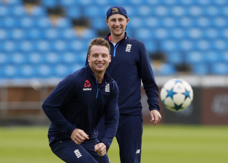 © Reuters. England's Joe Root and Jos Buttler play football during nets