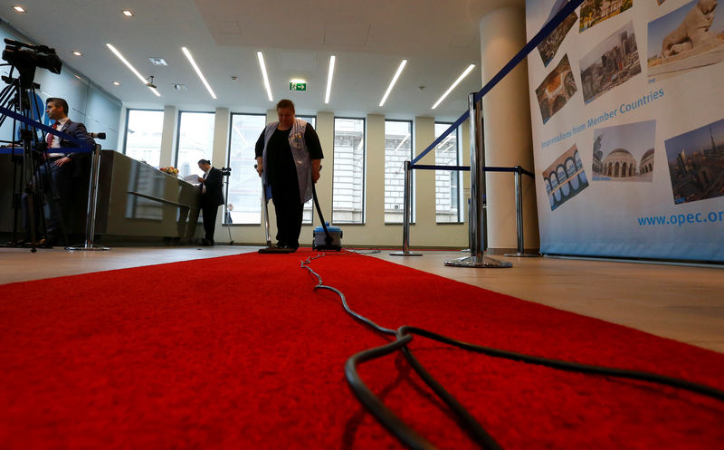 © Reuters. A women cleans the red carpet inside the OPEC headquarters in Vienna