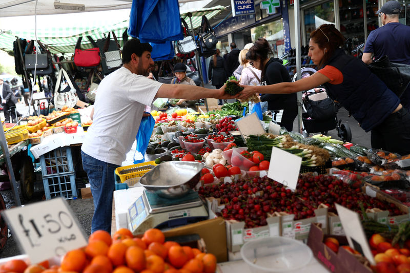 © Reuters. A woman buys produce at a market stall in London