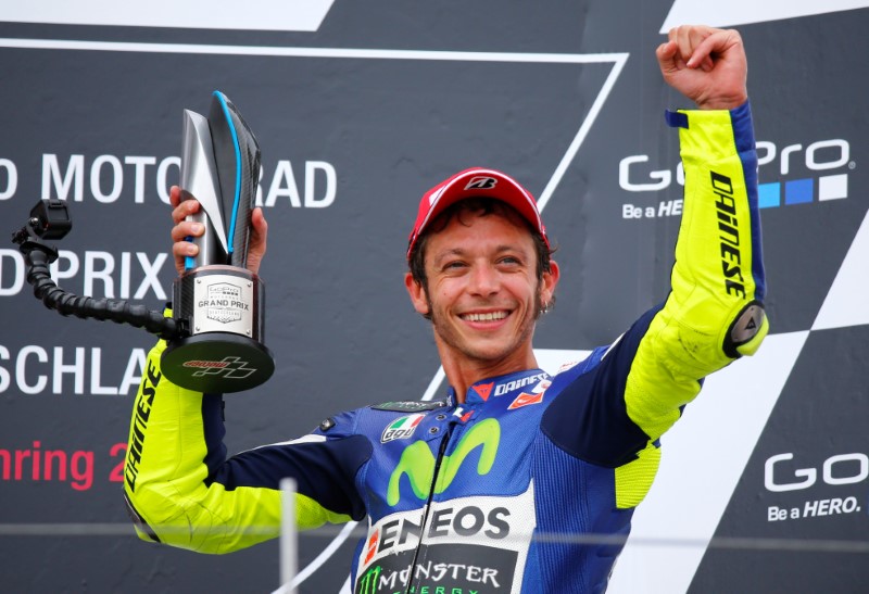 © Reuters. FILE PHOTO - Movistar Yamaha MotoGP rider Rossi celebrates with trophy after finishing third in the German Grand Prix MotoGP at the Sachsenring circuit in the eastern town of Hohenstein-Ernstthal