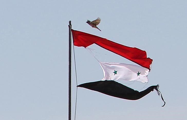 © Reuters. Bandeira da Síria rasgada é vista na cidade de Qamishli