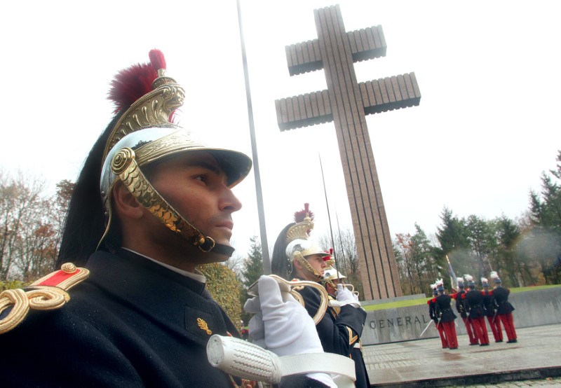 © Reuters. French Republican guards attend a ceremony in front the Croix de Lorraine at the Charles De Gaulle Memorial in Colombey-les-Deux-Eglises