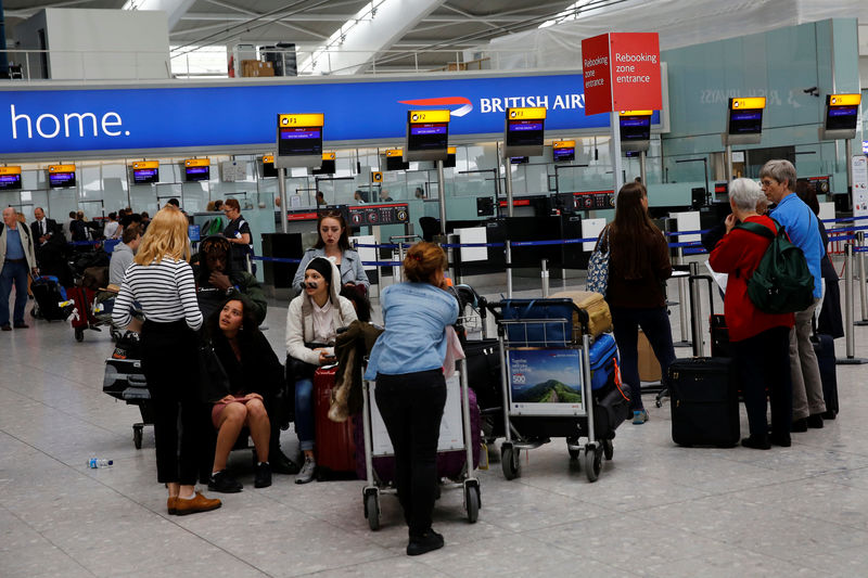 © Reuters. People wait with their luggage at a rebooking zone at Heathrow Terminal 5 in London