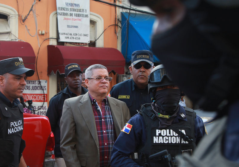 © Reuters. Roberto Rodriguez, former director of national water authority INAPA, is being escorted into a courthouse in Santo Domingo