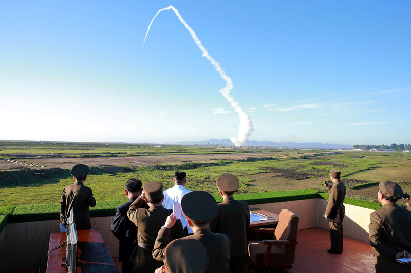 © Reuters. FILE PHOTO: North Korean leader Kim Jong Un watches the test of a new-type anti-aircraft guided weapon system organised by the Academy of National Defence Science