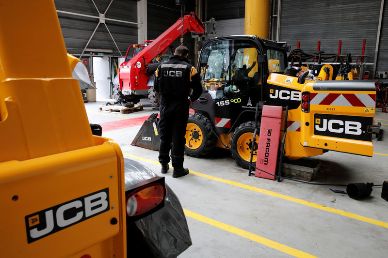 © Reuters. An employee works on a skid steer loader manufactured by JC Bamford Excavators Ltd. at the JCB France headquarters in Sarcelles