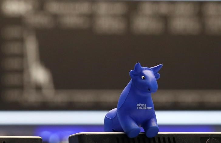 © Reuters. A plastic bull figurine, symbol of the Frankfurt stock exchange is pictured in front of the share price index DAX board at the stock exchange in Frankfurt