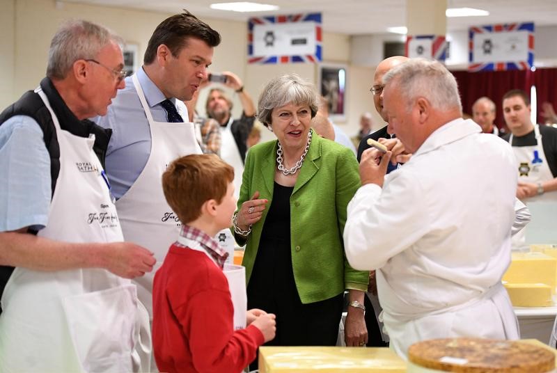 © Reuters. Britain's Prime Minister Theresa May samples cheese at the Royal Bath and West Show in Shepton Mallet