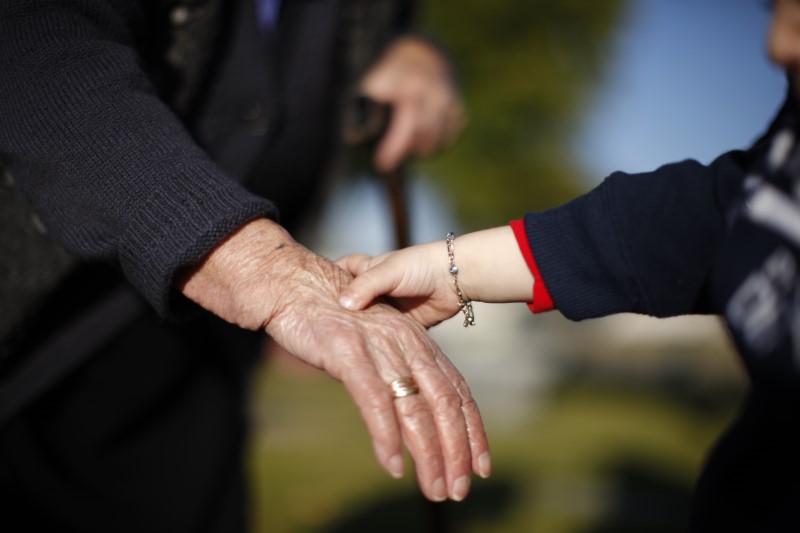 © Reuters. Hands are held in Sun City