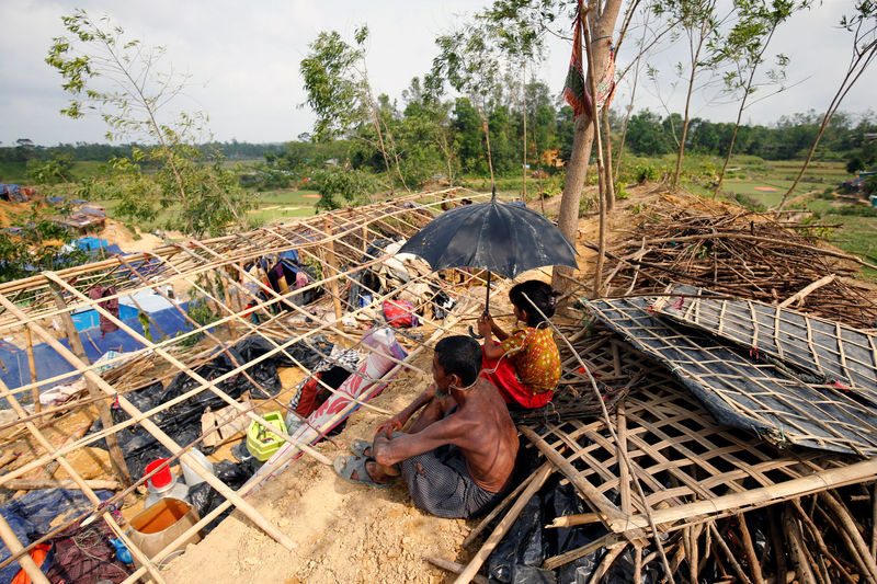 © Reuters. Rohingya refugees sit in front of their house which has been destroyed by Cyclone Mora at the Balukhali Makeshift Refugee Camp in Cox’s Bazar