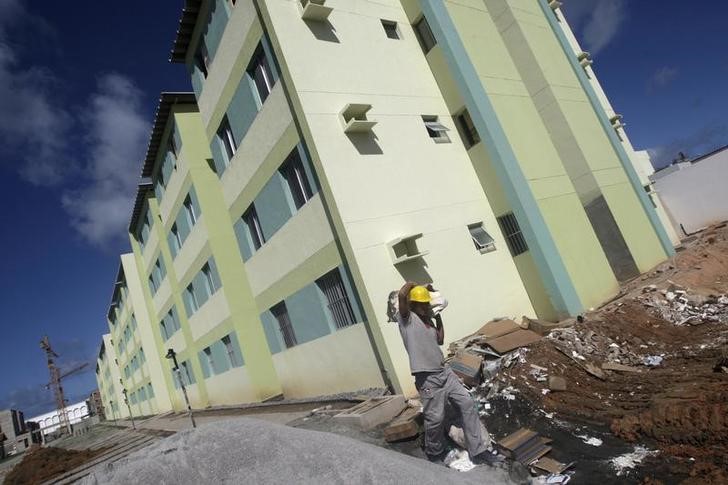 © Reuters. Funcionário passa por construção de prédios do programa Minha Casa Minha Vida, em Olinda