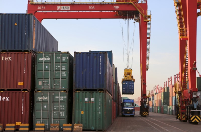 © Reuters. A container box is loaded on to a truck at a port in Rizhao