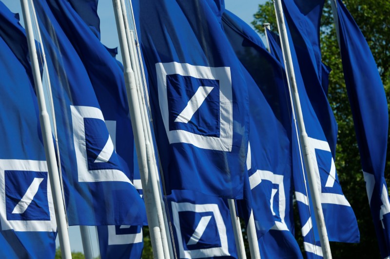 © Reuters. FILE PHOTO: Flags with the logo of Deutsche Bank are seen at the headquarters ahead of the bank's annual general meeting in Frankfurt