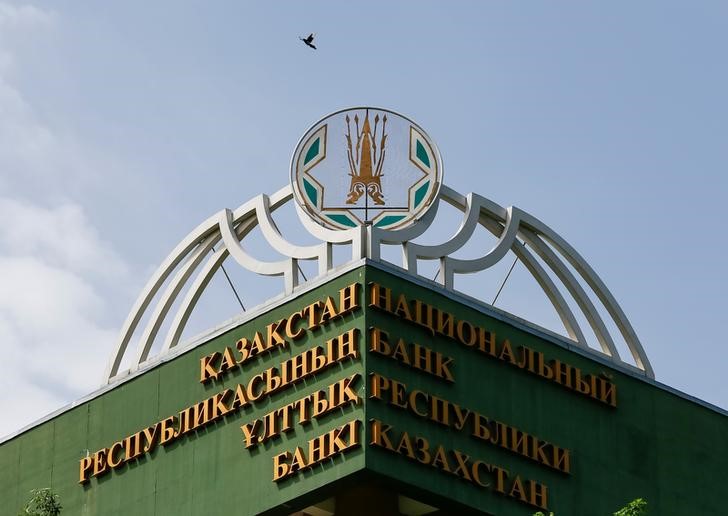 © Reuters. A bird flies above the logo of National Bank of Kazakhstan at the bank's headquarters in Almaty