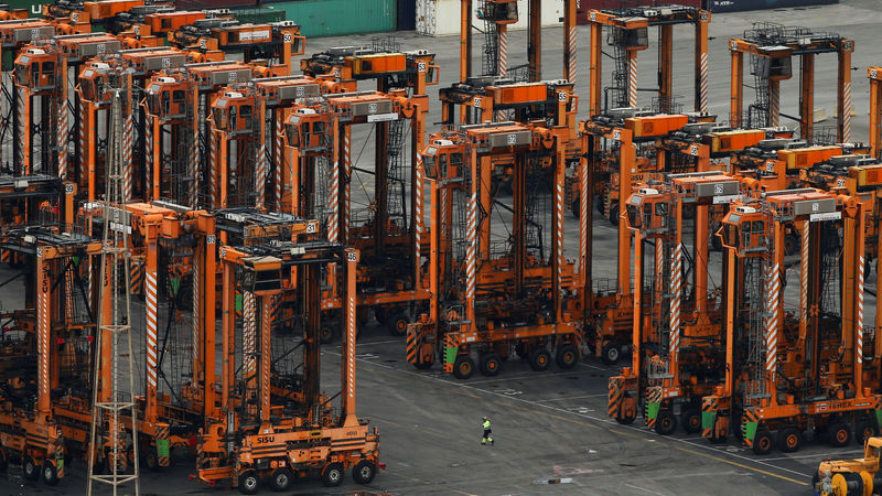 © Reuters. A port worker is seen amongst idle machinery during a strike at Barcelona's port