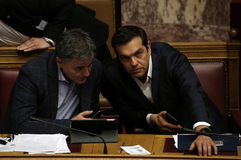 © Reuters. FILE PHOTO: Greek Prime Minister Alexis Tsipras and Finance Minister Euclid Tsakalotos attend a parliamentary session before a vote on the latest round of austerity Greece has agreed with its lenders, in Athens