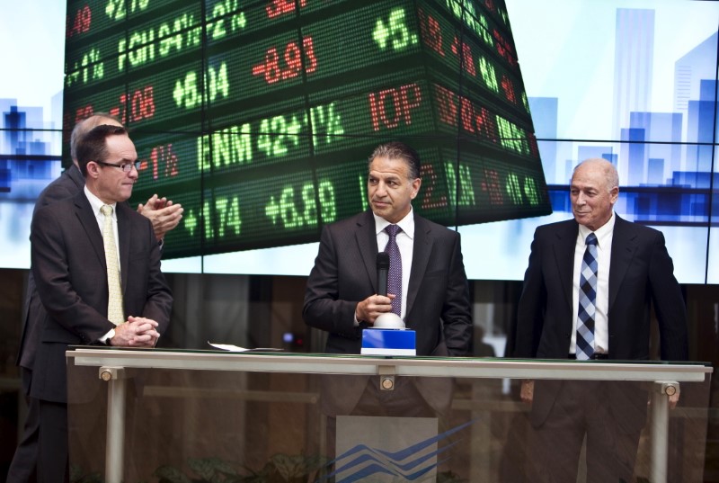 © Reuters. FILE PHOTO: Coury, Chairman and Chief Executive Officer of Mylan stands next to Neubach, the chairman of Tel Aviv Stock Exchange during a bell ringing ceremony at the Tel Aviv Stock Exchange, Israel
