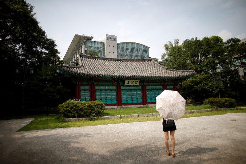 © Reuters. A student stands in front of Bicheondang at the Sungkyunkwan University in Seoul