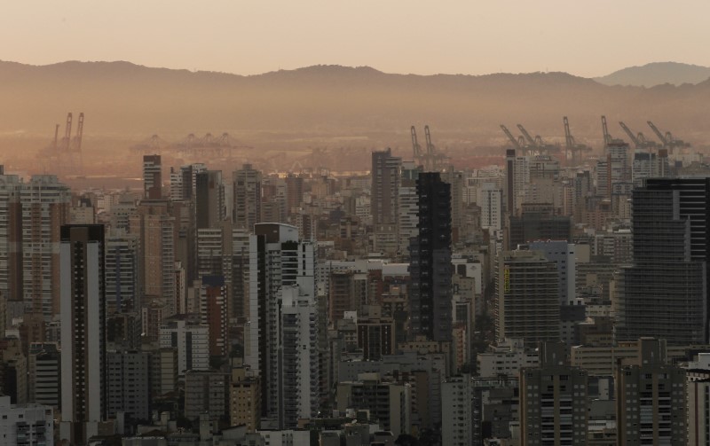 © Reuters. FILE PHOTO: Cranes are seen in the distance during a workers' strike at Latin America's biggest container port in Santos