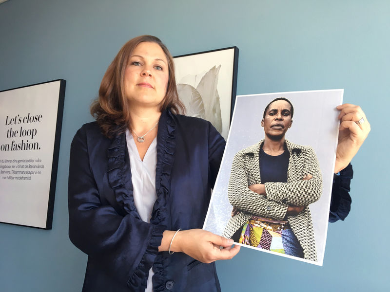 © Reuters. H&M Foundation Global Manager Amini poses with portraits of women in Stockholm