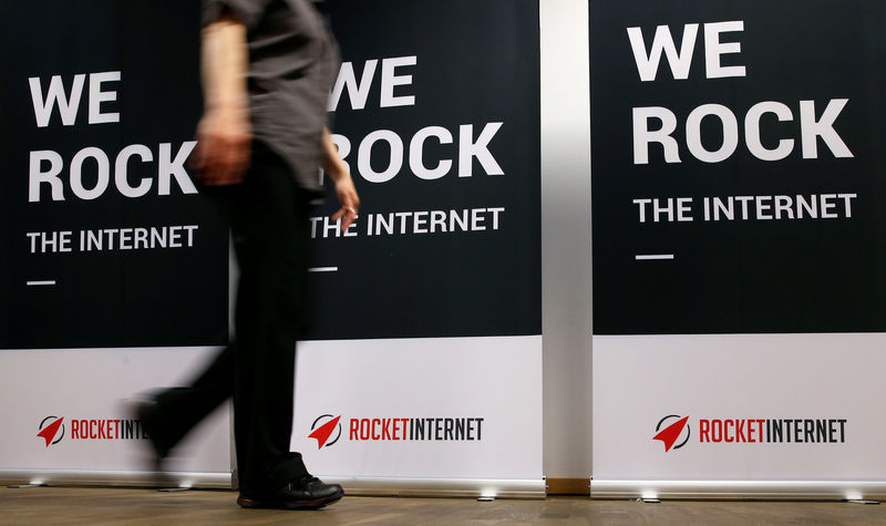© Reuters. FILE PHOTO: A woman walks past a banner at the shareholder meeting of Rocket Internet, a German venture capital group in Berlin