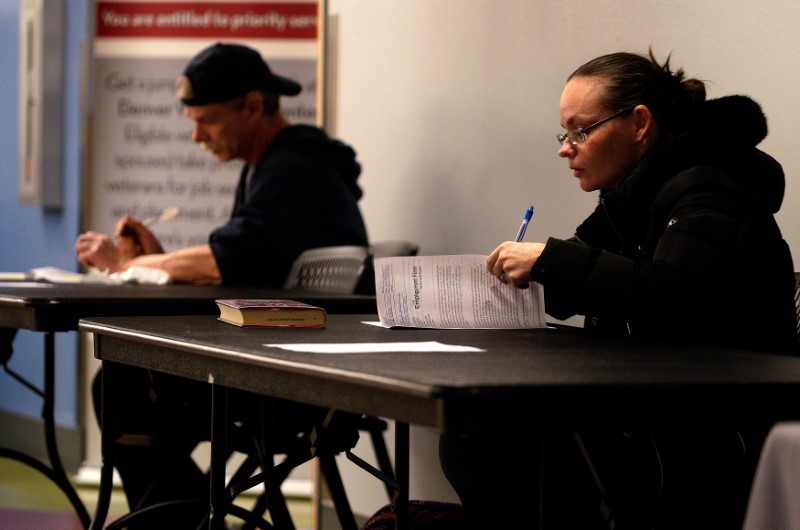 © Reuters. usecJob seekers fill out applications at a job fair at the Denver Workforce Center in Denver