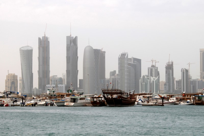 © Reuters. FILE PHOTO: Traditional fishing Dhows are seen in port near modern glass and steel buildings on the Doha skyline