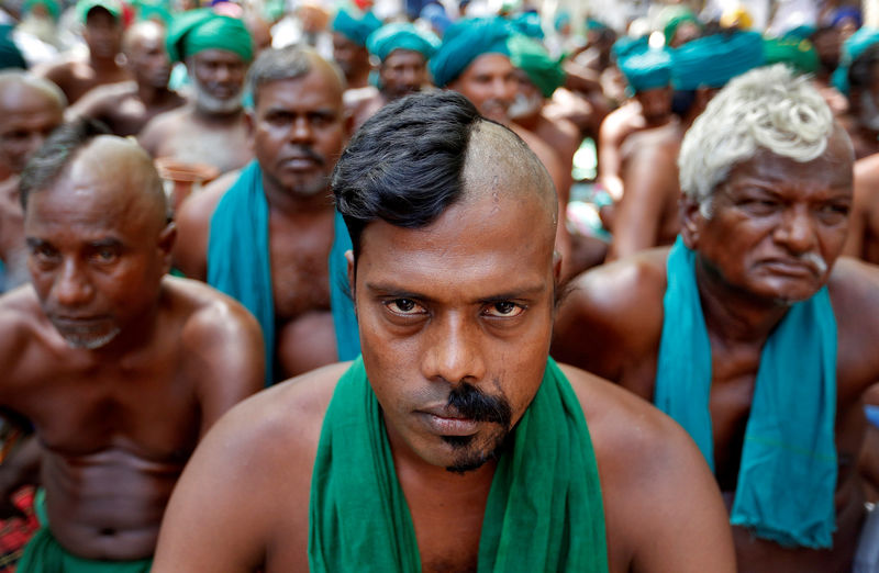 © Reuters. FILE PHOTO: Farmers from the southern state of Tamil Nadu pose half shaved during a protest demanding a drought-relief package from the federal government, in New Delh