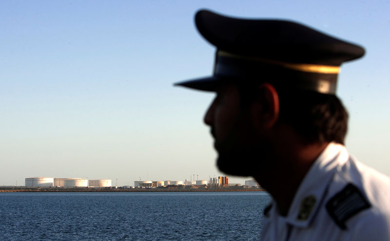 © Reuters. FILE PHOTO: A member of security personnel looks on at oil docks at the port of Kalantari in the city of Chabahar