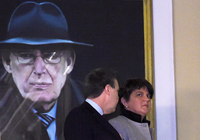 © Reuters. FILE PHOTO: Northern Ireland First Minister and leader of the Democratic Unionist Party Arlene Foster walks past a portrait of Ian Paisley after speaking at Parliament Buildings in Stormont in Belfast