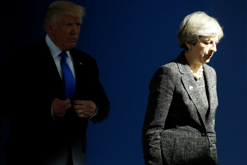 © Reuters. U.S. President Trump and Britain's PM May walk at the start of the NATO summit at their new headquarters in Brussels