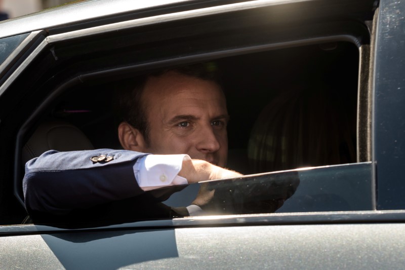 © Reuters. French President Emmanuel Macron leaves polling station after voting in parliamentary elections in Le Touquet